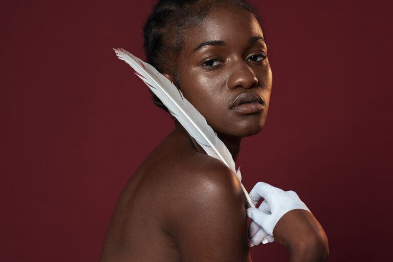 woman-posing-with-feather-side-view